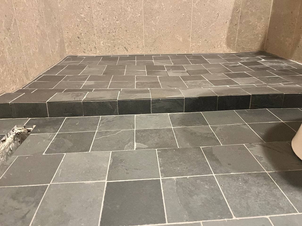 Slate tile floor and shower curb